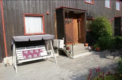 a house with a porch and a window and a building at Cozy small bedroom flat in Trondheim