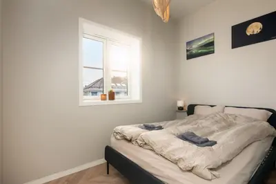 a bedroom with a bed with a window at 3F - In the heart of Trondheim in Trondheim