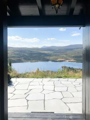 a view of a lake from the window of a house at Cabin With Panoramic View At Vaset in Ron