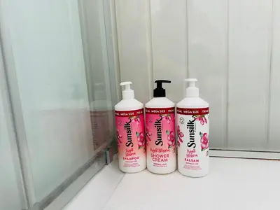 three shampoo bottles sitting on a window sill at Central apartment - Free parking and Wi-Fi in Lillehammer