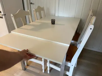 a white table and chairs with a cup on it at Central apartment - Free parking and Wi-Fi in Lillehammer