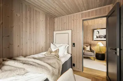a bedroom with a bed with a blanket at Premium Cabin By Kvitfjell Ski Slopes in Ringebu