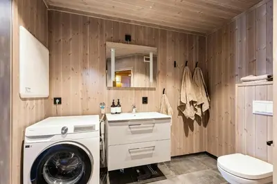 a bathroom with a washing machine and a sink at Premium Cabin By Kvitfjell Ski Slopes in Ringebu