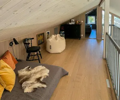 a dog laying on a bed in a room at Architect Designed Cabin With Panoramic Views in Ål