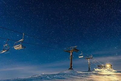 a ski lift on top of a snow covered slope at Cabin With Ski Inski Out In Rauland in Rauland