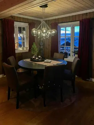 a dining room with a table and chairs and a chandelier at Cabin With Ski Inski Out In Rauland in Rauland