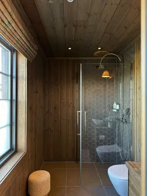 a bathroom with a shower and a toilet and a sink at Architect-Designed Mountain Cabin At Mosetertoppen in Øyer