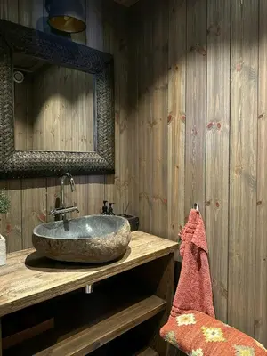 a bathroom with a stone sink and a mirror at Architect-Designed Mountain Cabin At Mosetertoppen in Øyer