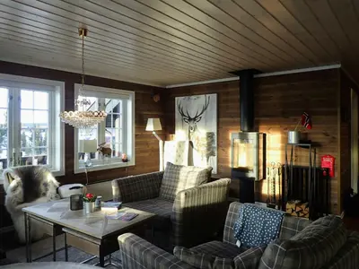 a living room with a couch and a table at Mountain Cabin With Views Over Nesfjellet in Nesbyen