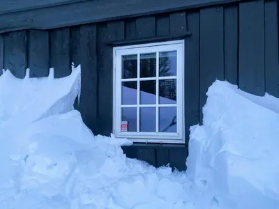 a window on a house with snow around it at Mountain Cabin With Views Over Nesfjellet in Nesbyen