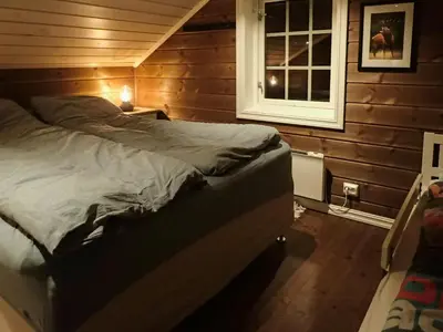 a bedroom with a bed in a room with a window at Mountain Cabin With Views Over Nesfjellet in Nesbyen