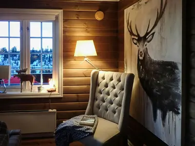 a bedroom with a painting of a deer on the wall at Mountain Cabin With Views Over Nesfjellet in Nesbyen