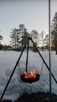 a fire in a swing in the snow at Charming Small Cabin At The Top Of Blefjell in Flesberg
