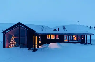 a house with a christmas tree in the snow at Architect Drawn Holiday Home Near Rondane Park in Høvringen