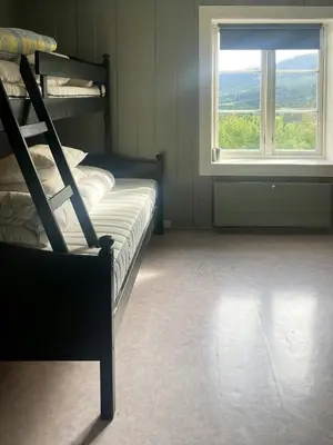a bedroom with a bunk bed and a window at Historic Old Rectory In The Heart Of Norway in Vestre Gausdal