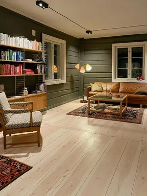 a living room with a couch and a table at Historic Old Rectory In The Heart Of Norway in Vestre Gausdal