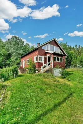 a red house on a hill with a green yard at Peaceful Smallholding With Yoga Studio in Traut