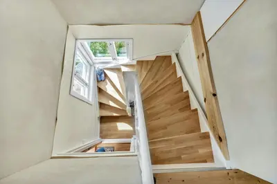 a staircase in a tiny house with a window at Peaceful Smallholding With Yoga Studio in Traut