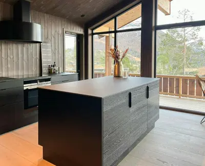 a kitchen with a island in the middle of a room at Stylish Cabin In Scenic Stryn in Stryn