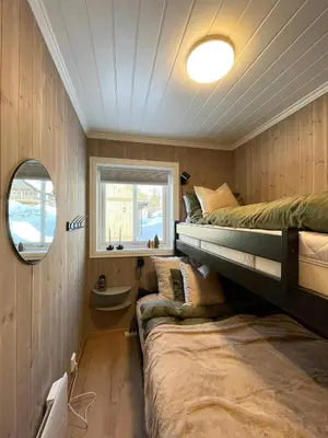a bedroom with two bunk beds and a window at Cozy Cabin With Ski-Inout At Raulandsfjell in Rauland