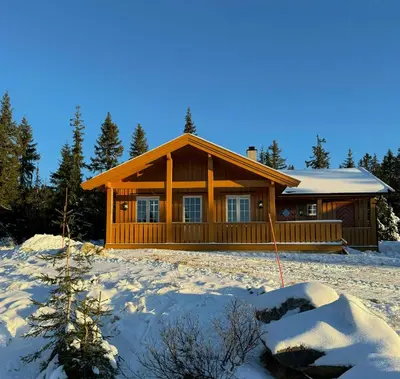 a log cabin with snow on the ground with at Family-Friendly Cabin In Nordseter Near Ski Trails in Lillehammer