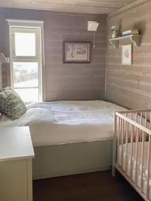 a small bedroom with a bed and a window at Traditional Cabin With Views Of Hardangervidda in Uvdal
