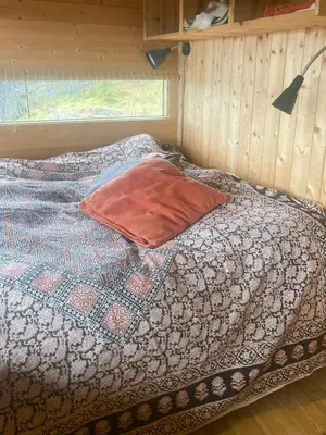 a bed with a pillow on it in a room at Ålhytte Near Vasetvannet in Ron