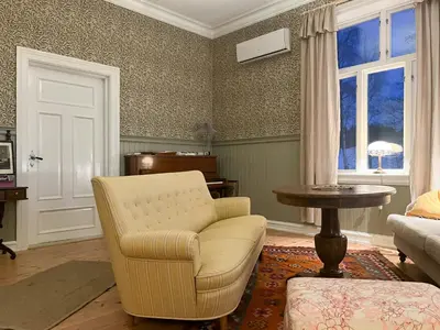 a living room with a chair and a table at Historic Property In Idyllic Snertingdal in Segard