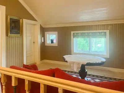 a living room with a couch and a window at Historic Property In Idyllic Snertingdal in Segard