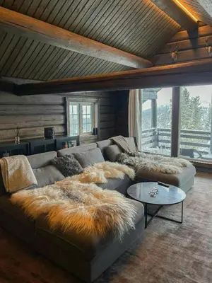 a living room with a couch with a faux fur blanket at Log Cabin With Views Over Trysil Mountain in Trysil