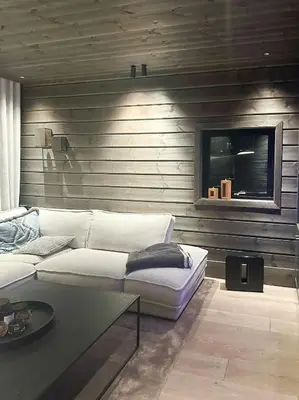 a living room with a white couch and a table at Unique Cabin With Spa And Ski In-Ski Out in Hemsedal