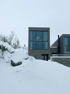 a building with a pile of snow in front of it at Unique Cabin With Spa And Ski In-Ski Out in Hemsedal