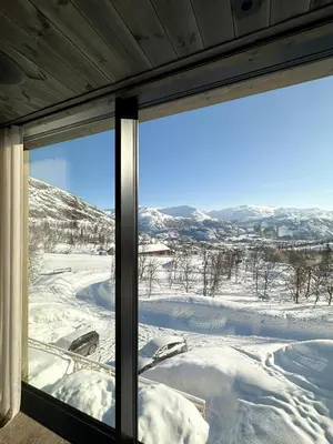 a view of a snow covered field from a window at Unique Cabin With Spa And Ski In-Ski Out in Hemsedal