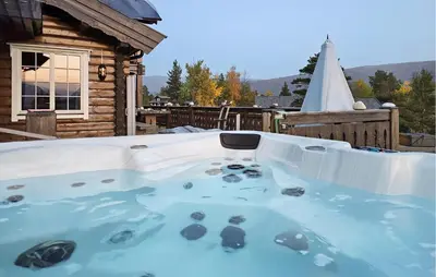 a hot tub on the deck of a house at Amazing Home In Lesjaskog With Wifi in Bjorli