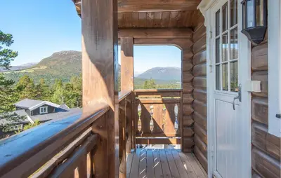 a view from the porch of a log cabin with a door at Amazing Home In Lesjaskog With Wifi in Bjorli