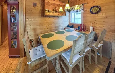 a wooden table and chairs in a dining room at 2 Bedroom Pet Friendly Home In Rendalen in Rendalen