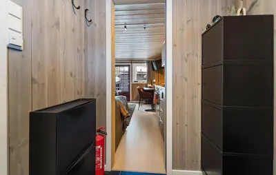 a hallway leading to a living room with a television at Amazing Apartment In Hovden I Setesdal in Hovden