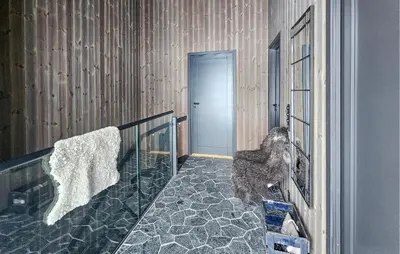 a room with a glass door with a cat on a bed at Awesome Home In Rjukan With Sauna in Rjukan