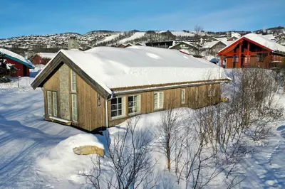 a house covered in snow in a city at New 4Bedroom Cabin With Sauna, Terrace & Fireplace in Beitostøl