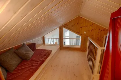 a living room with a couch in a attic at New 4Bedroom Cabin With Sauna, Terrace & Fireplace in Beitostøl