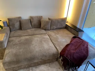 a brown couch sitting in a living room at Modern, big and central apartment in Trondheim in Trondheim