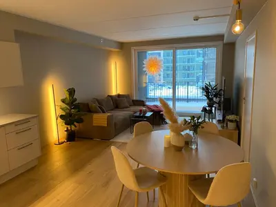 a living room with a table and a couch at Modern, big and central apartment in Trondheim in Trondheim