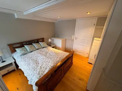 a bedroom with a large bed with pillows on it at 2 roms kjellerleilighet med separat soverom in Luster