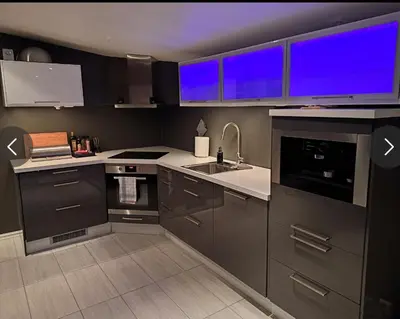 a kitchen with gray cabinets and a sink at Ski inn Ski Out Best holiday Apartments i Oppdal in Oppdal