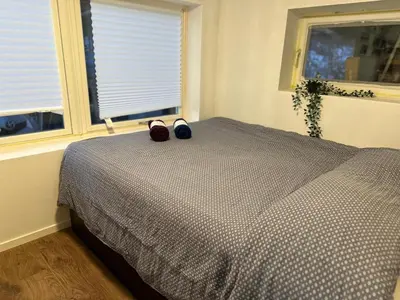 a bedroom with a bed with a pair of shoes on it at Gjestehus i Trondheim, under VM 2025 in Trondheim