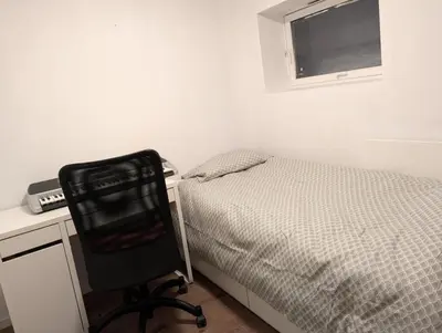 a bedroom with a bed and a desk and a chair at Gjestehus i Trondheim, under VM 2025 in Trondheim