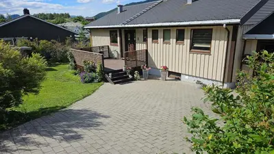 a house with a brick driveway next to a house at Apartment in Rauma in Veblungsnes