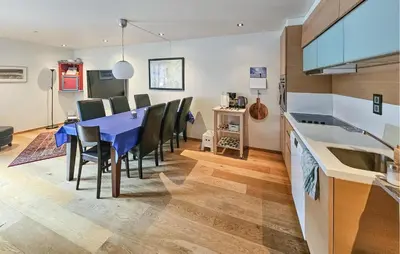 a kitchen and dining room with a blue table and chairs at 5 Bedroom Cozy Apartment In Ustaoset in Ustaoset