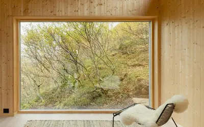 a window in a room with a chair in front of it at Architect Drawn Cabin With Sea View At Stokkøy in Hosen