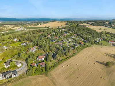an aerial view of a farm with a field at Ringåsen in Berg